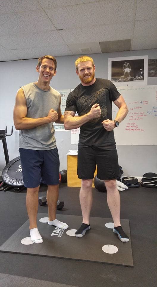 Ben and Trey Tucker flexing together inside PowerHouseATX