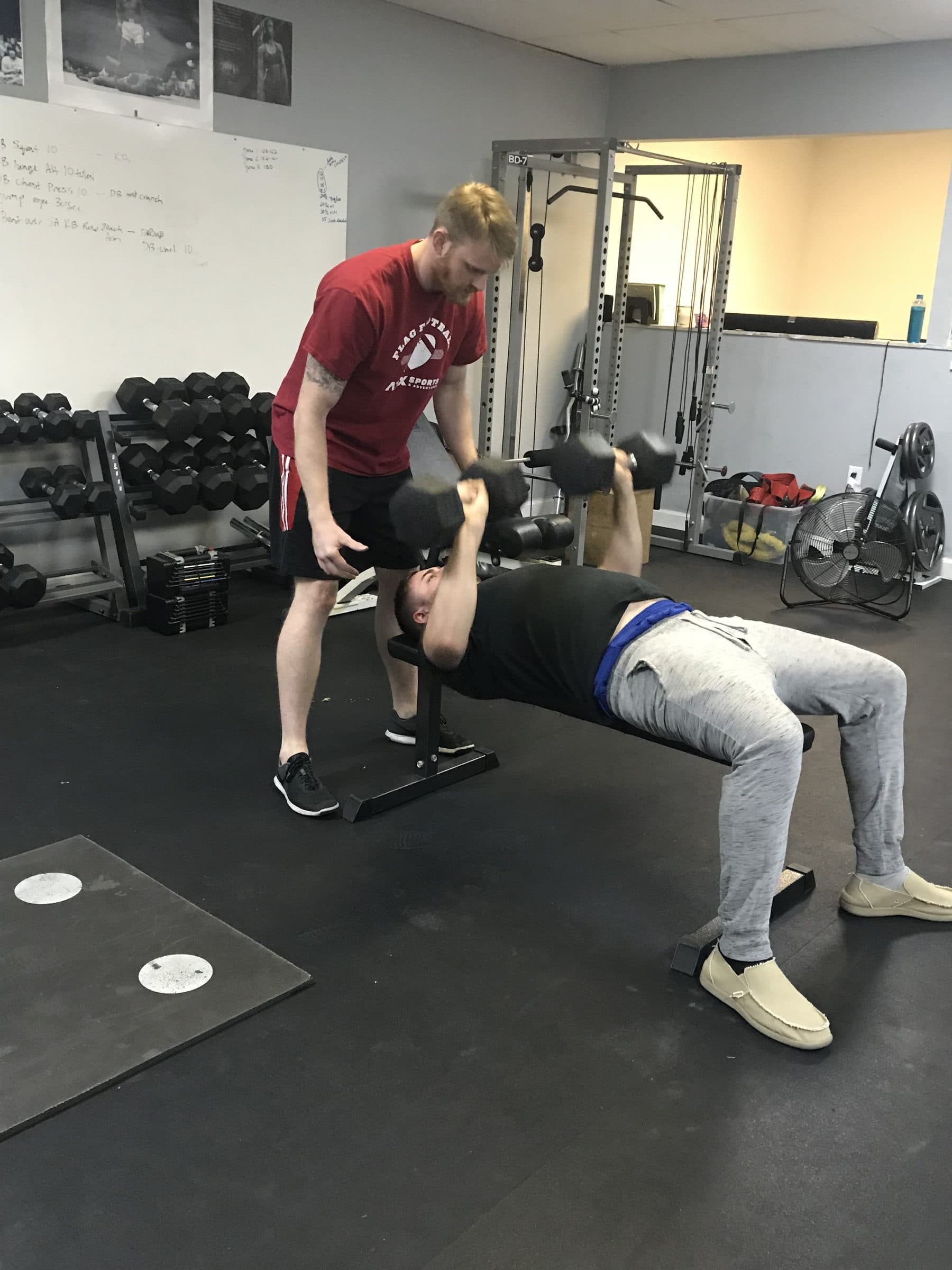 One-on-one coaching during a dumbbell bench press at PowerHouseATX