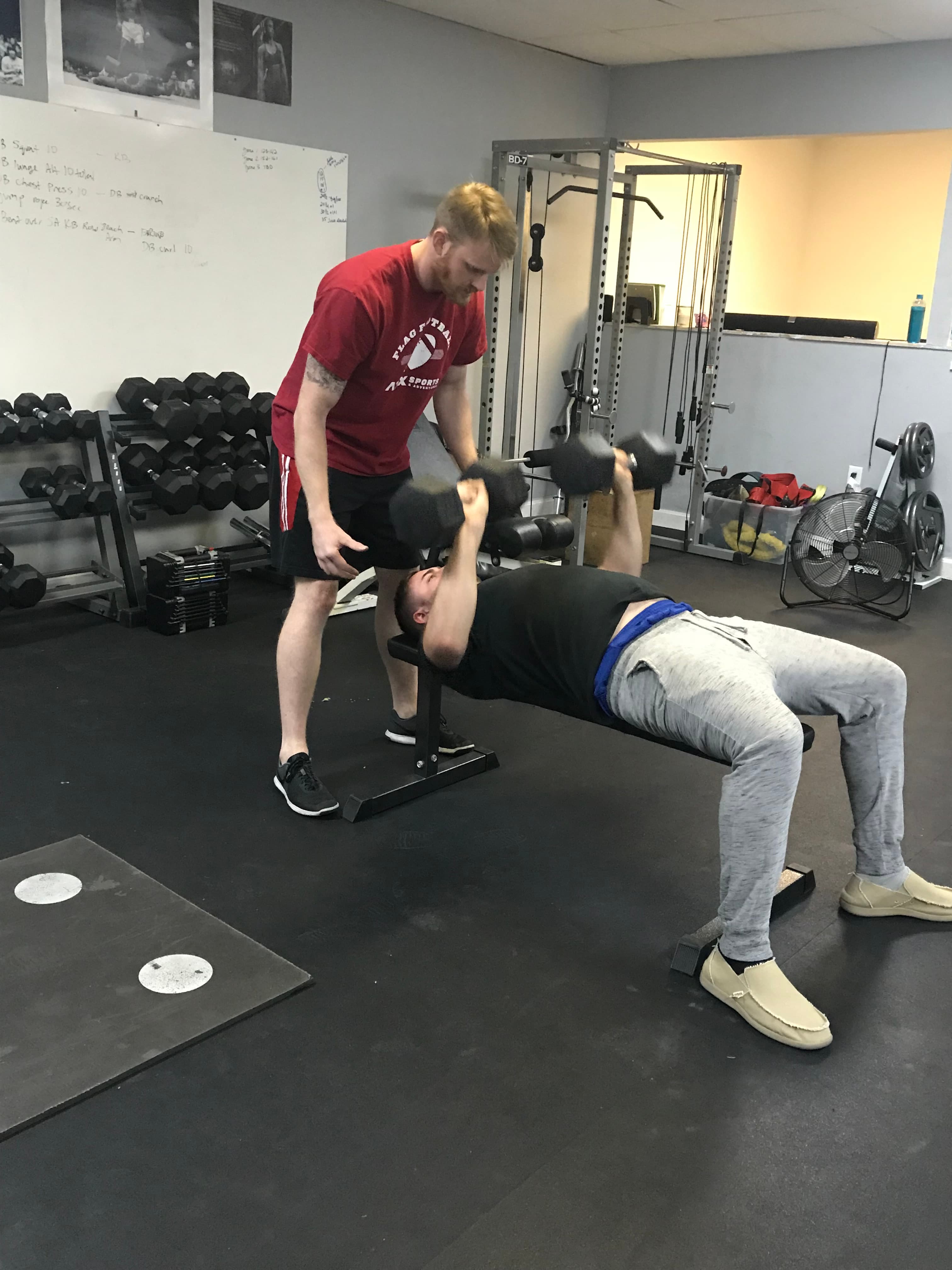 One-on-one coaching during a dumbbell bench press at PowerHouseATX